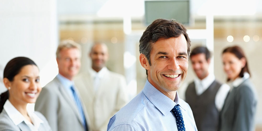 Corporate team members smiling for posed shot